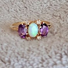 10k Gold Ring With Opel, Diamonds, And Amethyst Stones Opal Center, Flanked By Two Matching Amethyst Stones, And Four Diamonds Surrounding The Opal. Size 6 1/4 Ring Was Recently Serviced (Prongs Are Tight). 10k Gold Ring, Amethyst Stones, Amethyst Stone, 10k Gold, Purple Gold, Gold Ring, Stone Color, Gold Jewelry, Gold Rings