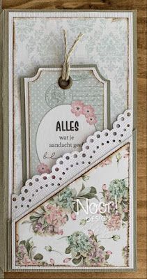 a card with some flowers on it and a tag hanging from the front of it