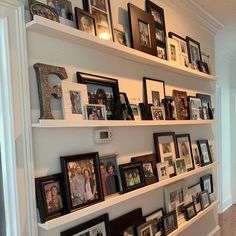 the shelves are filled with pictures and family photos