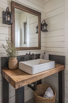 a bathroom sink sitting under a mirror next to a wooden shelf with a basket on it