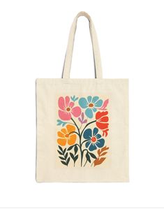 a tote bag with an image of flowers on the front and bottom, in multi - colored colors