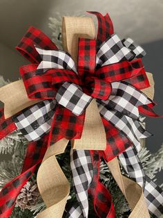 a christmas tree decorated with red, white and black plaid ribbon