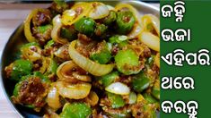 a bowl filled with pasta and vegetables on top of a wooden table next to a green sign