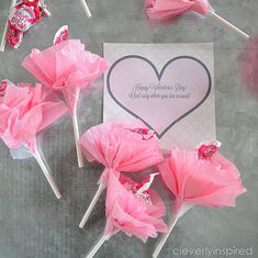 candy lollipops are arranged around a valentine's card