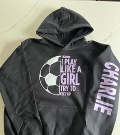 a black hoodie that says i know i play like a girl try to keep up