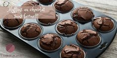 chocolate cupcakes in a muffin tin on a wooden table