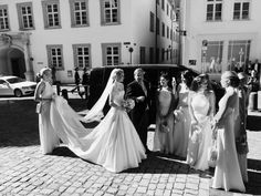 the bride and her bridal party are getting out of their limo