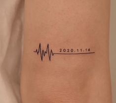 a woman's arm with a heartbeat tattoo on it