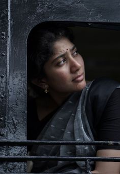 a woman looking out the window of a train