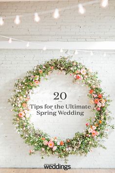 a white brick wall with flowers and greenery on it that says 20 tips for the ultimate spring wedding