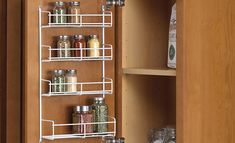 an organized spice rack in a kitchen cupboard