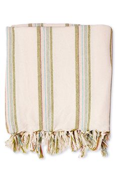 a white and green striped towel with tassels