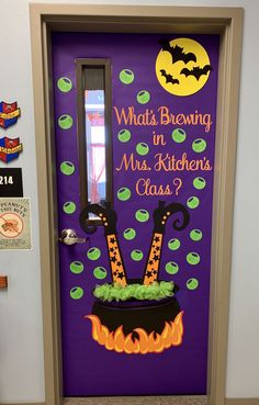 a door decorated with an image of a witch's hat and legs on fire