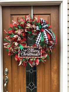 a merry christmas wreath on the front door