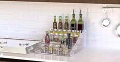 a kitchen counter with wine bottles and glasses on it