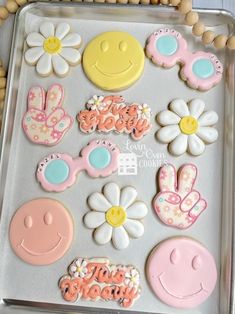 decorated cookies in the shape of smiley faces and flowers