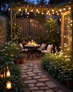 an outdoor dining area is lit up with string lights and surrounded by greenery, potted plants, and patio furniture