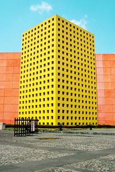 a large yellow building sitting on the side of a road