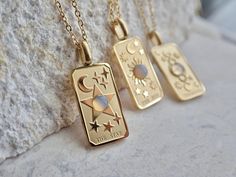 "I'm so excited to introduce my new line of high quality, anti-tarnish, waterproof jewelry.   Thanks to our special plating technique, this celestial beauty is built to last, both pendant and chain are anti tarnish and waterproof.  Crafted with hypoallergenic 18k gold stainless steel,  it's lead and nickel free and safe and comfortable for sensitive skin.  Your choice of pendants feature three of my favorite Major Arcana cards and a sweet little faux opal cabochon for an added touch of mystery.  Choose from  The Moon, The Star, or The Sun Perfect for gifting or treating yourself. THE DETAILS Chain: 18k gold specially coated Stainless Steel Chain Length: 16\" with an additional 2\" extension chain Pendant: 18K Gold Stainless Steel.   1.1\" high by .4\" wide *Will arrive ready for gifting in Celestial Rectangular Pendant Jewelry Gift, Celestial Style Rectangular Pendant Jewelry Gift, Tarot Card Necklace, Plating Techniques, Major Arcana Cards, Card Necklace, Jewelry Opal, Tarnished Jewelry, Opal Pendant Necklace