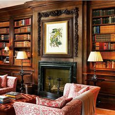 a living room filled with furniture and bookshelves covered in lots of bookcases