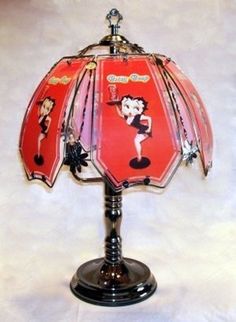 a lamp with an umbrella shade on top of it