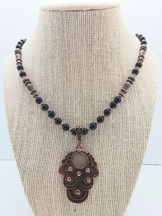 Beautiful shiny black Onyx gemstones with an unusual copper plated pendant.  Base metal is a hypoallergenic alloy.  The color combination gives off a nice rich tone complimenting this necklace.  The necklace is 18 inches long wiith a hypoallergenic lobster clasp. Copper Plated, Beaded Necklaces, Color Combination, Base Metal, Gemstone Necklace, Black Onyx, Lobster Clasp, Necklace Etsy, Onyx