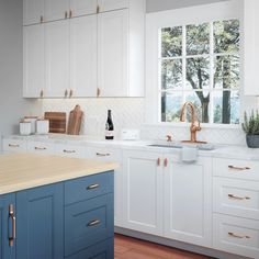 a kitchen with white cabinets and blue drawers