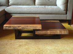 a living room with a couch, coffee table and sofa in the background on carpeted floor