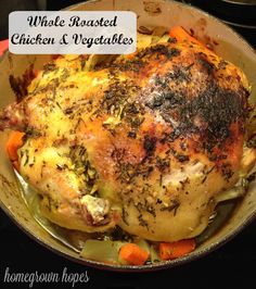 roasted chicken and vegetables in a skillet on the stove with text overlay that reads roasted chicken and vegetables