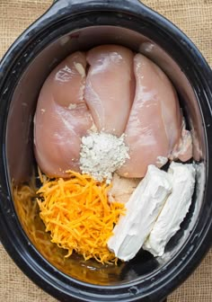 chicken and cheese are in the crock pot ready to go into the slow cooker