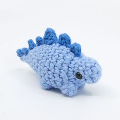 a blue crocheted toy fish with black eyes