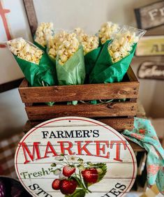 fresh strawberries and popcorn in a wooden crate