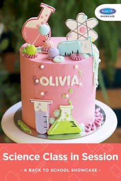 a pink cake with the words science class in session written on it, and an image of a beakle