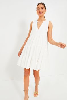 A customer favorite and all time best-seller, the Kenzo dress is hot weather ready in our new, sleeveless version. Featuring a soft white swiss dot fabric, V-neckline, and loose empire waist, this flirty frock is the most flattering day to night dress. Pair with sandals for a casual day look or dress it up with espadrilles and statement earrings for dinner with friends. V-neckline Sleeveless Empire waist Tiered skirt Mini length Lined Swiss dot fabric Material: 100% Cotton Care: Machine wash col White V-neck Sleeveless Dress For Summer, White V-neck Sleeveless Summer Dress, Knee-length White V-neck Dress For Day Out, White Knee-length V-neck Dress For Day Out, White Knee-length V-neck Dress For Vacation, Summer V-neck Sleeveless Dress For Daywear, White Knee-length V-neck Dress For Summer, White Knee-length V-neck Summer Dress, Chic White Empire Waist Mini Dress