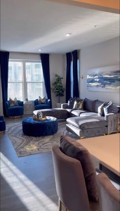 a living room filled with furniture and blue curtains