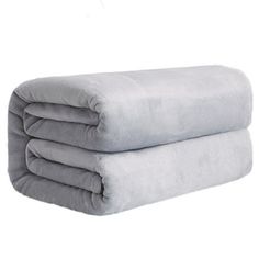 three blankets stacked on top of each other in front of a white background and one is folded