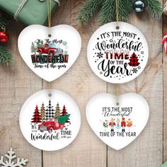 three ornaments hanging from a wooden table with christmas decorations and presents around them, including an ornament that says it's the most wonderful time of the year