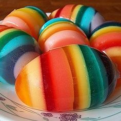 there are rainbow colored candies on the plate