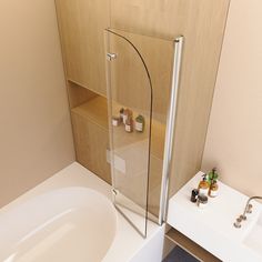 a bathroom with a glass shower door next to a white sink and bathtub in it