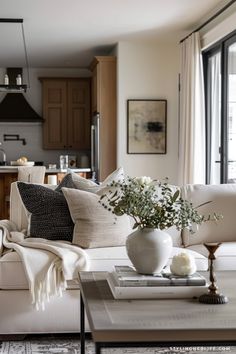 a living room filled with furniture next to a window