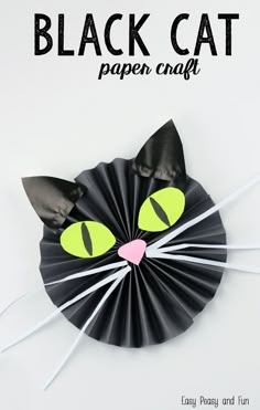 a black cat paper craft with yellow eyes