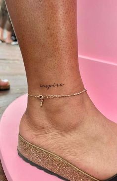 a woman's foot with a small ankle tattoo on the side of her leg