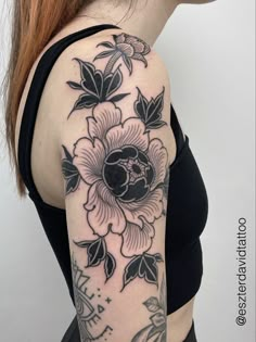 a woman with a black and white flower tattoo on her arm