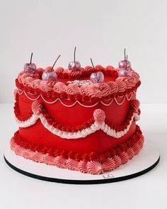 a red and white cake sitting on top of a table