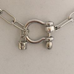 Carabiner Chain choker Carabiner Chain Necklace-Choker Necklace-Clasp Chain Necklace-Silver Cable Necklace-Silver Shackle Necklace-Shackle Jewelry-Padlock Charm A beautiful shiny silver chain made up of paperclip links. The chain is brass and has several plating coatings of color to give the silver electroplated finish. It is a high quality chain choker chain. The anchor shackle clasp gives the necklace a modern and unusual edge. It is Silver Plated - Rhodium Plated. Size 21 x 25 mm To finish of Silver Metal Necklace With Carabiner Clasp, Silver Necklace With Carabiner Clasp In Metal, Silver Link Chain Necklace With Carabiner Clasp, Silver Link Jewelry With Carabiner Clasp, Silver Toggle Choker Necklace With Lobster Clasp, Necklace Clasp, Choker Chain, Silver Choker Necklace, Necklace Clasps