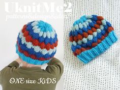 a small child wearing a blue and red knitted hat next to a white wall