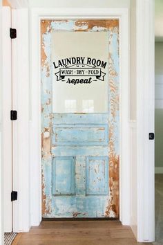 an old door is painted blue and has the word laundry on it