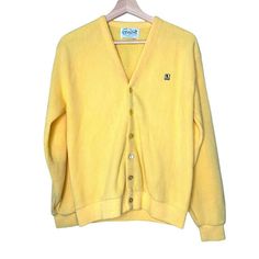 "Vintage Grandpa Yellow Pages Mr. Rogers Cardigan Holy Mr. Rogers, check out this cool vintage grandpa cardigan sweater Made in the USA Wool blend Canary yellow Vintage brand Ferranti Button front Size M Approx flat measurements: Chest 22\" Waist 17\" Sleeves 23\" Length 24.5\"" Classic Yellow Winter Cardigan, Classic Yellow Long Sleeve Cardigan, Vintage Crew Neck Cotton Cardigan, Retro Cotton V-neck Outerwear, Vintage Yellow Cotton Sweater, Retro Cotton Cardigan With Button Closure, Vintage V-neck Cardigan With Button Closure, Vintage Cotton V-neck Outerwear, Yellow Long-sleeve Cardigan With Button Closure