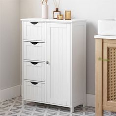 a white cabinet sitting next to a sink in a bathroom