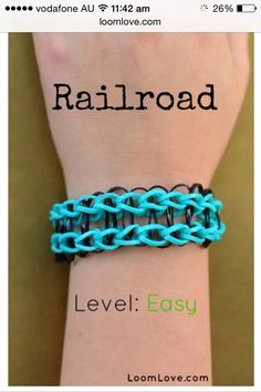 a person wearing a blue and black bracelet with the word railroad written on it's wrist